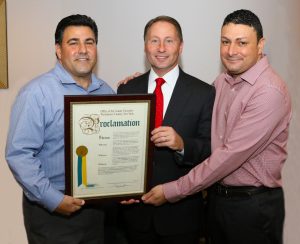 Westchester County Executive, Robert Astorino, presents the proclamation to owners John Ruggiero and Ray Sassano. 