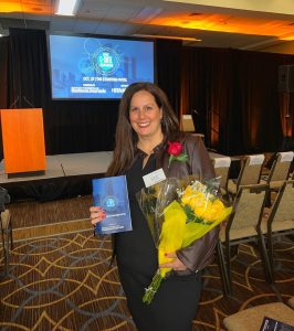 Christina Rae holding award